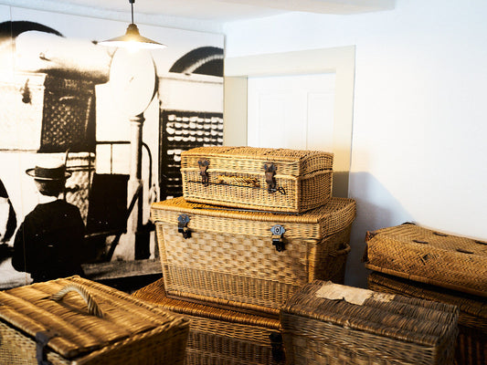 Stacked willow trunk baskets with leather straps displayed inside the Dalhausen Basket Maker Museum, Germany ダルハウゼンかご職人博物館に展示された革ベルト付きのやなぎ製トランク型かご