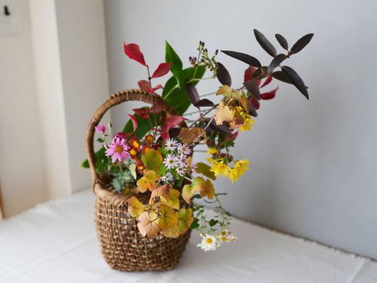 あけびのかごに野花をいけた室内の静かな風景 / Wildflowers arranged in an akebi vine basket indoors